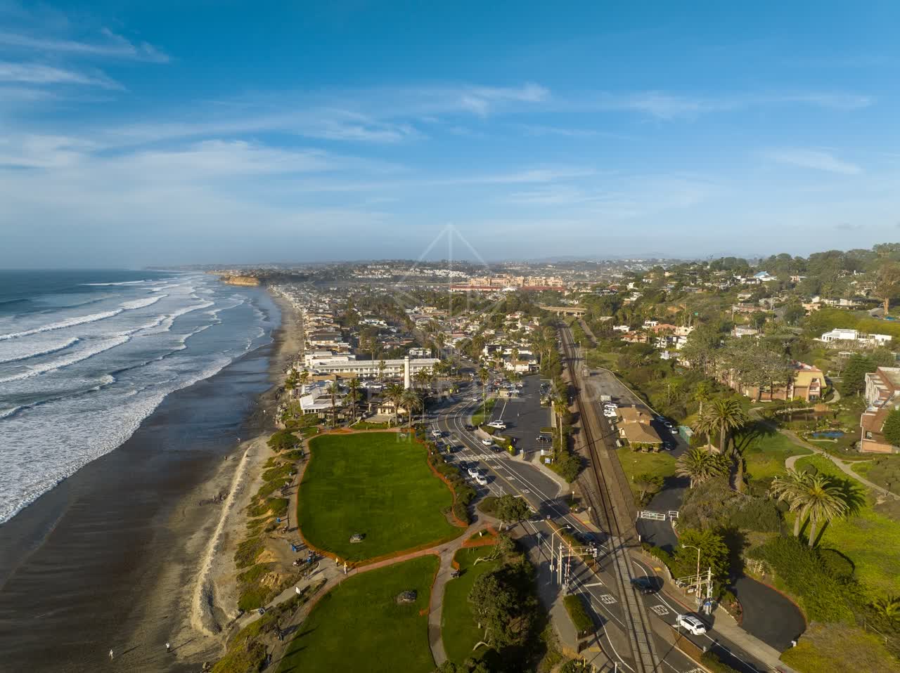 Aerial view of the beach, the surf and palm trees in Del Mar.