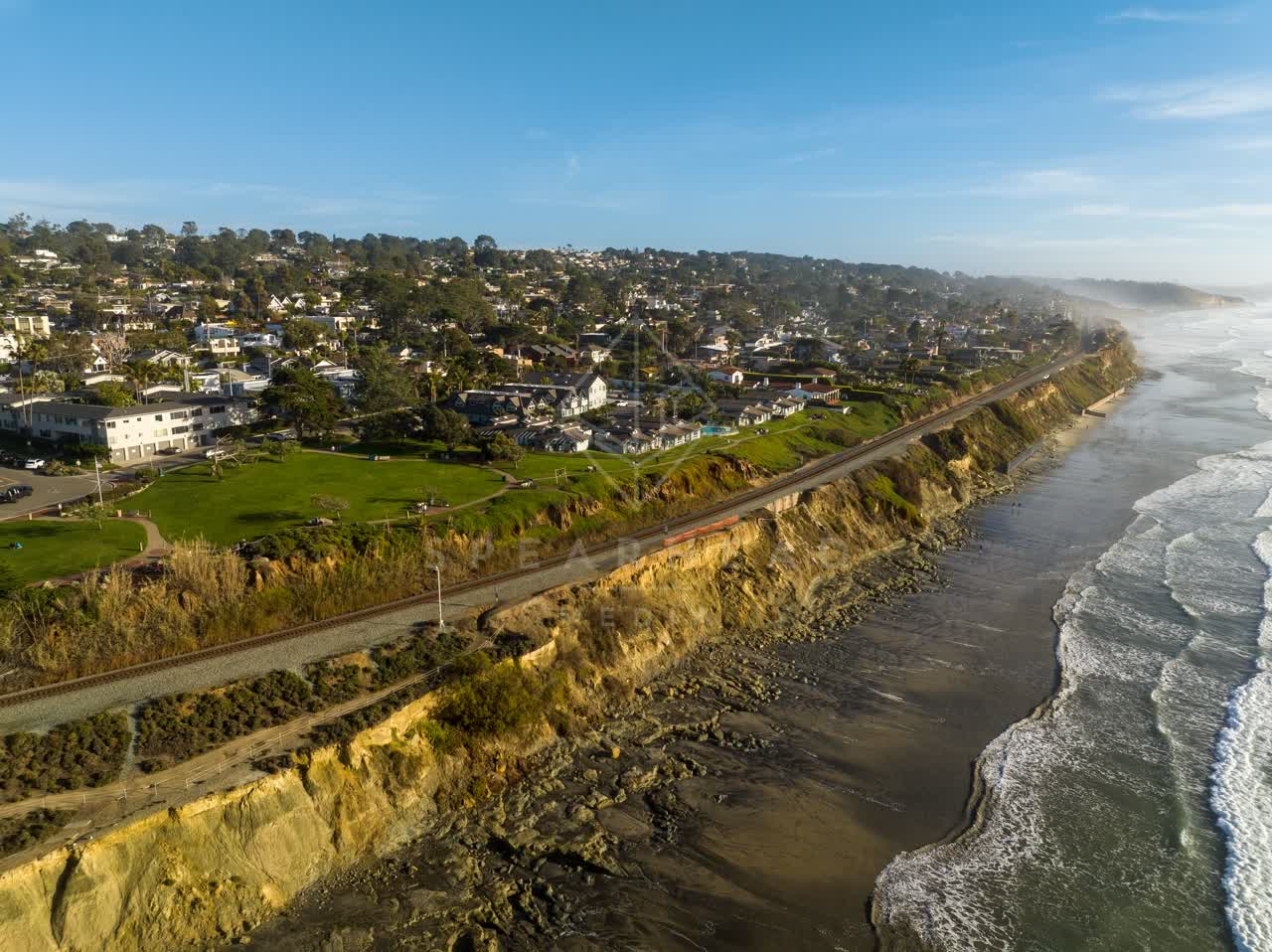 Aerial view of the cliffs, the surf and the ocean in Del Mar.