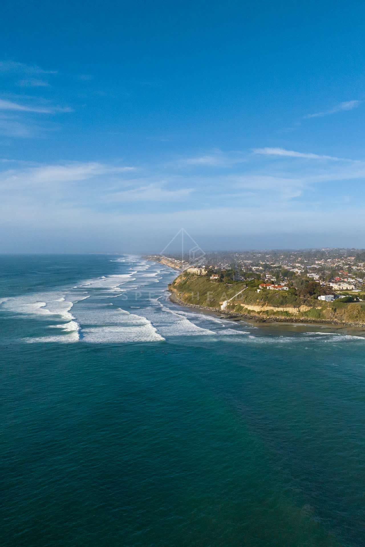 Aerial view of the cliffs, the surf and the ocean at Swamis.