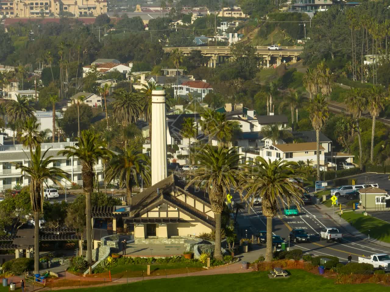 A residential street, palm trees and homes in Del Mar.
