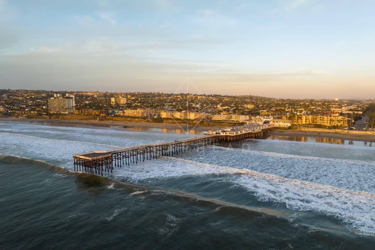 Aerial view of the beach, the surf and the pier in Pacific Beach.