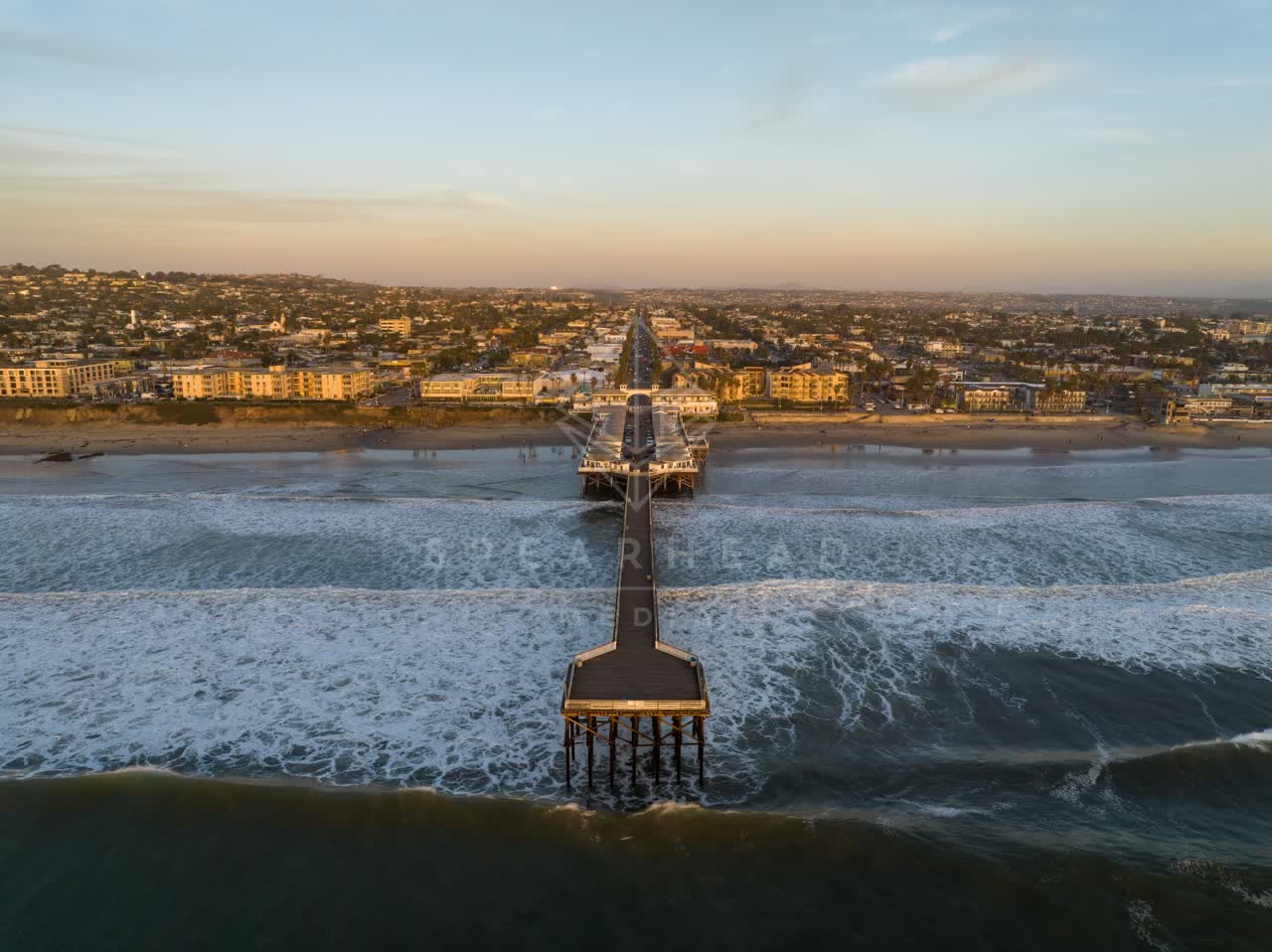 Aerial view of the beach, the surf and the pier in Pacific Beach.