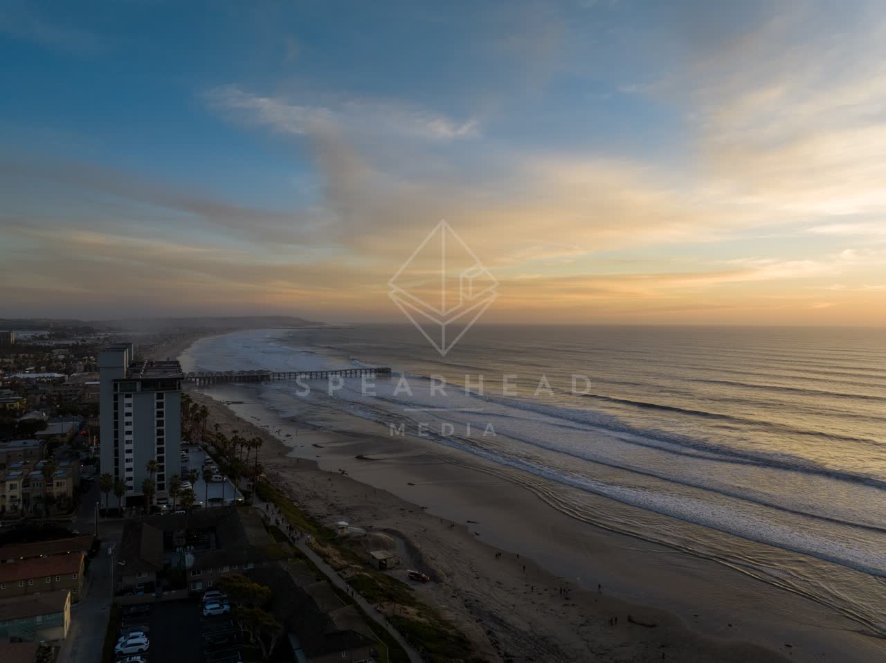 Aerial view of the beach, the surf and the pier in Pacific Beach.