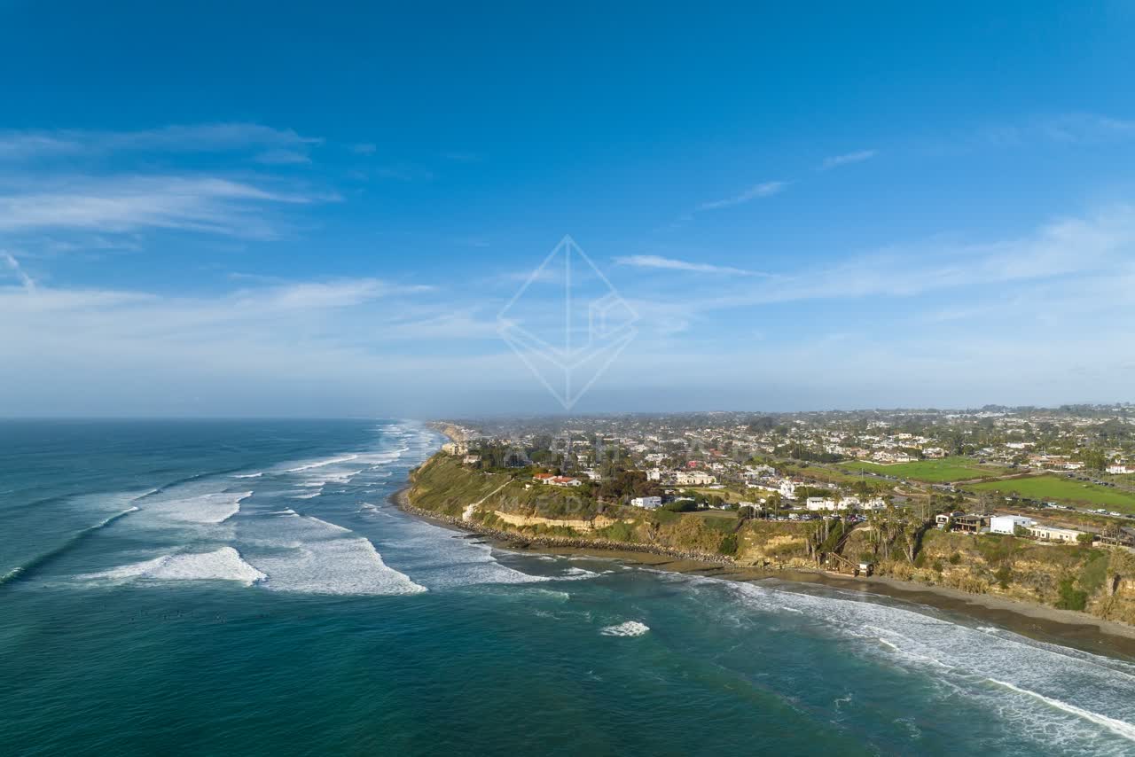 Aerial view of the cliffs, the surf and the ocean at Swamis.