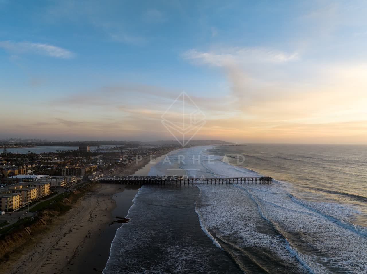 Aerial view of the beach, the surf and the pier in Pacific Beach.