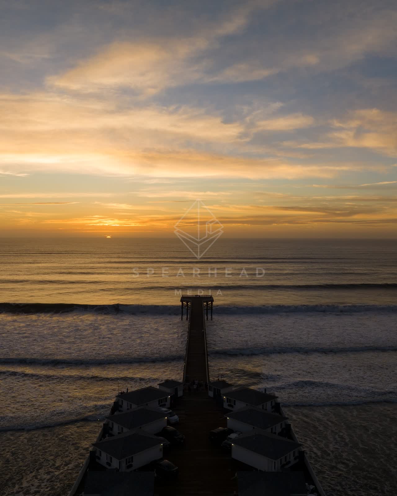 Aerial view of the beach, the surf and the pier in Pacific Beach.
