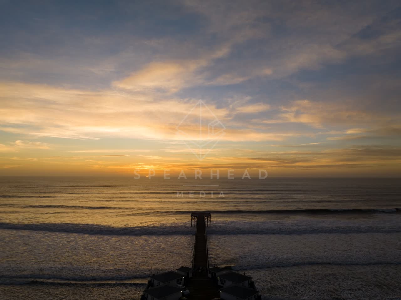 Aerial view of the beach, the surf and the pier in Pacific Beach.