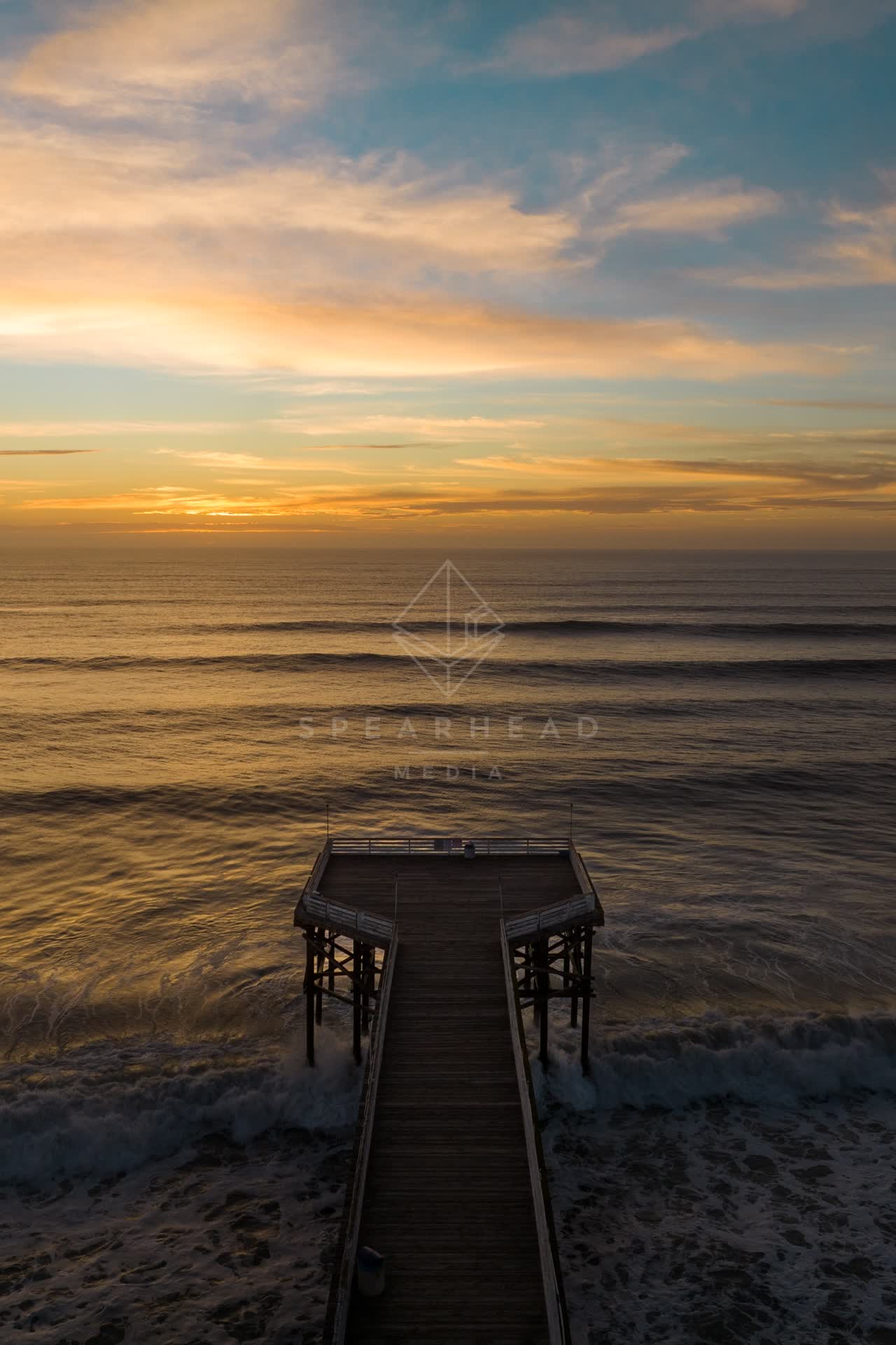 Aerial view of the beach, the surf and the pier in Pacific Beach.