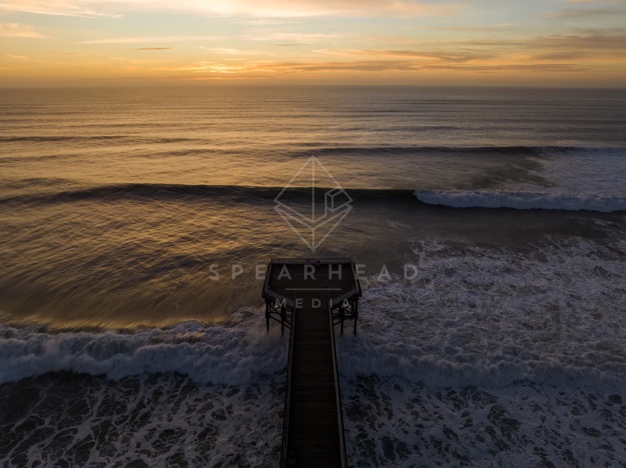Aerial view of the beach, the surf and the pier in Pacific Beach.
