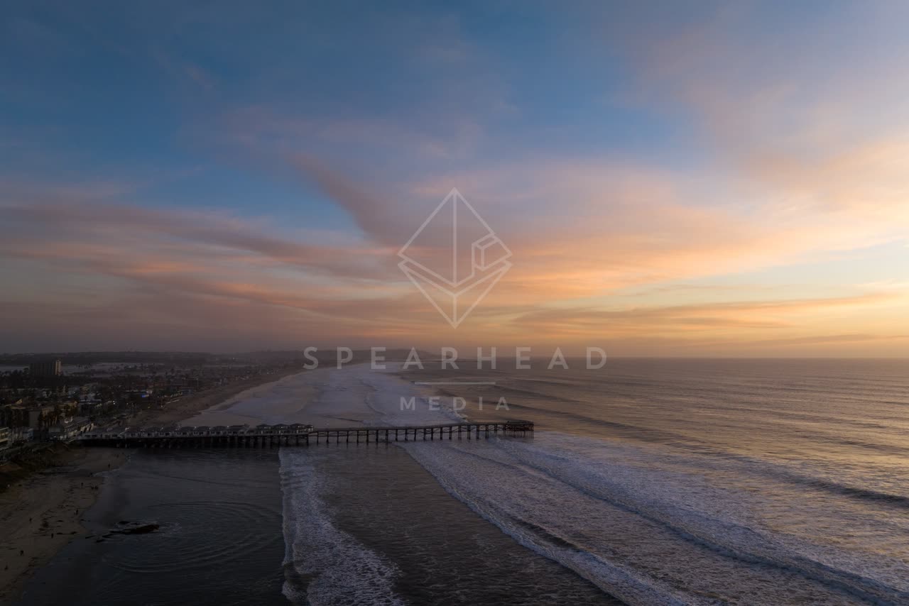 Aerial view of the beach, the surf and the pier in Pacific Beach.