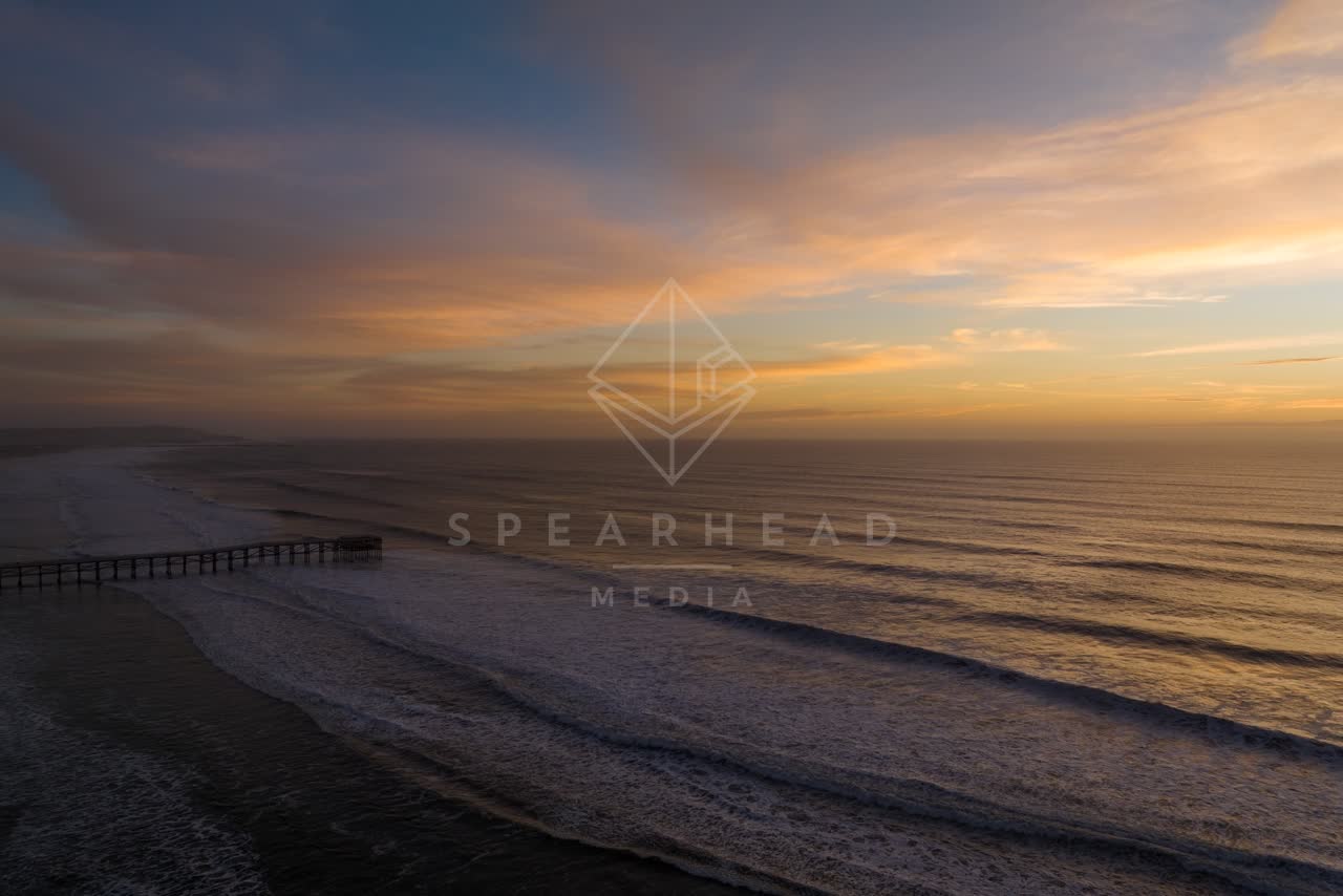 Aerial view of the beach, the surf and the pier in Pacific Beach.