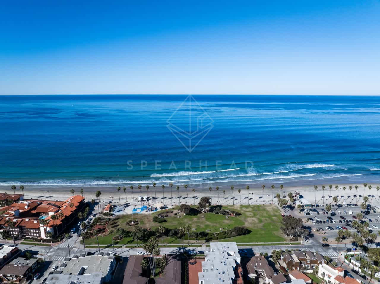 Aerial view of the beach, the surf and palm trees at La Jolla Shores.