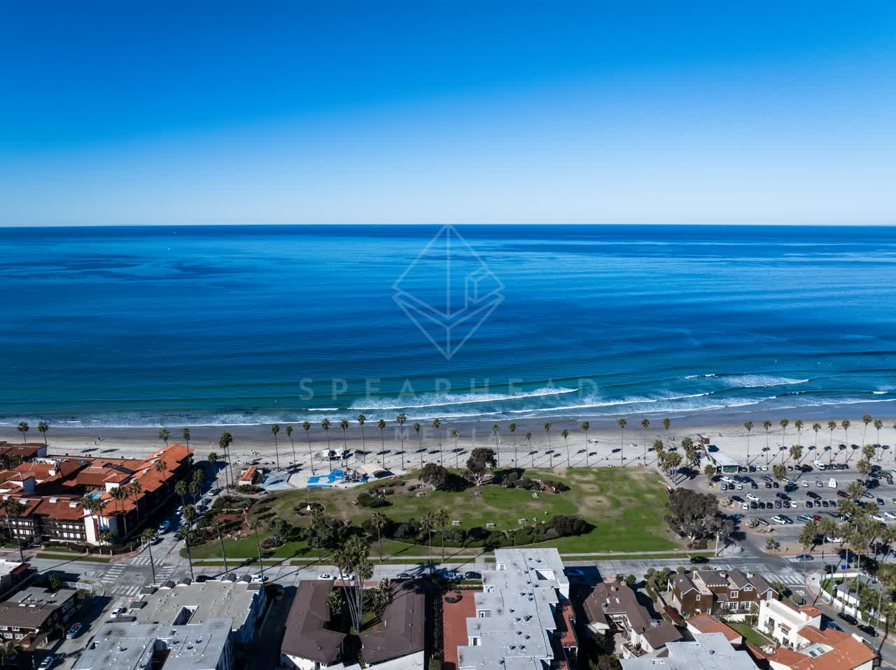 Aerial view of the beach, the surf and palm trees at La Jolla Shores.