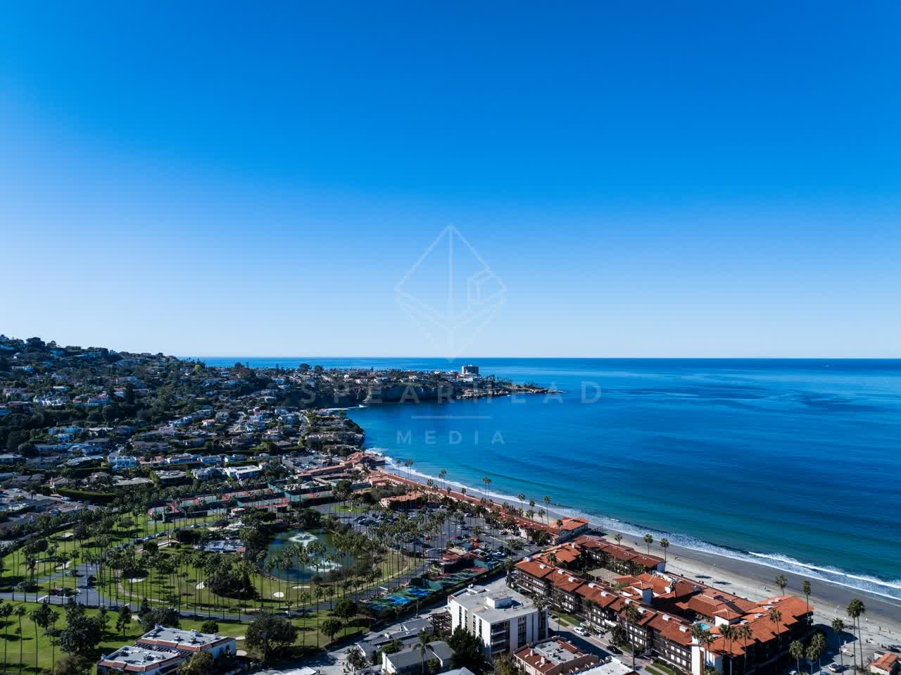 Aerial view of the beach, palm trees and the ocean at La Jolla Cove.