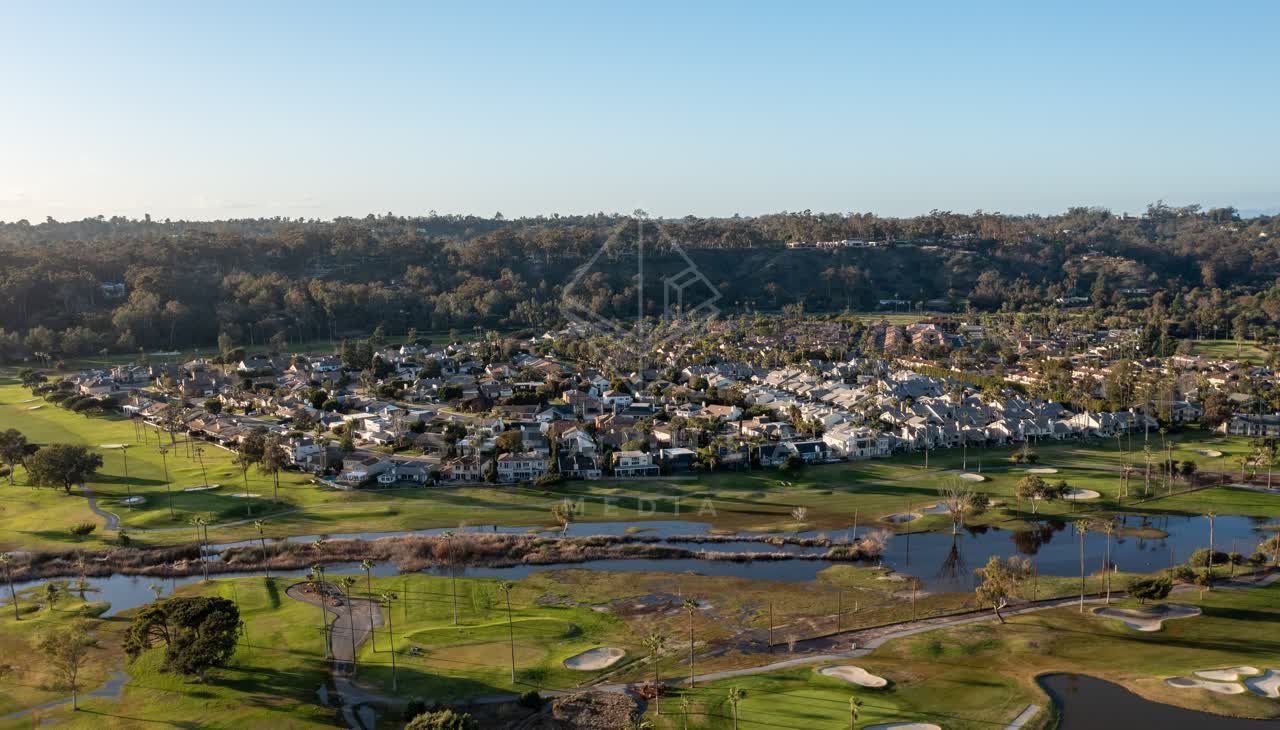 Aerial view of a residential street, palm trees and homes at Fairbanks Ranch.