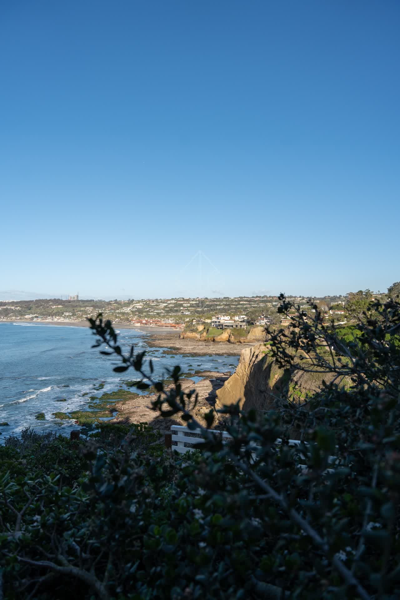 Elevated view of the cliffs, the ocean and homes at Coast Walk Trail.