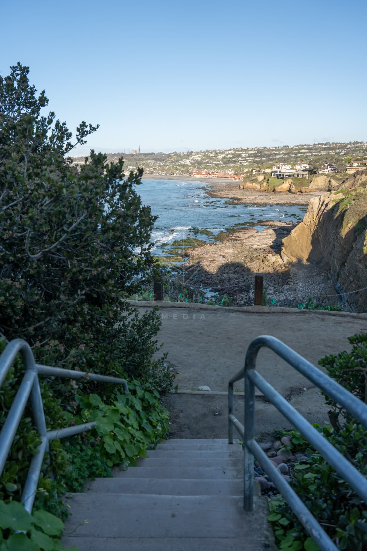 Elevated view of the cliffs, the ocean and homes at Coast Walk Trail.