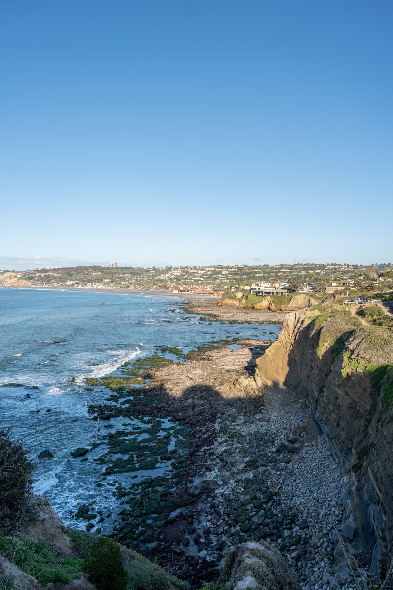 Elevated view of the cliffs, the ocean and homes at Coast Walk Trail.