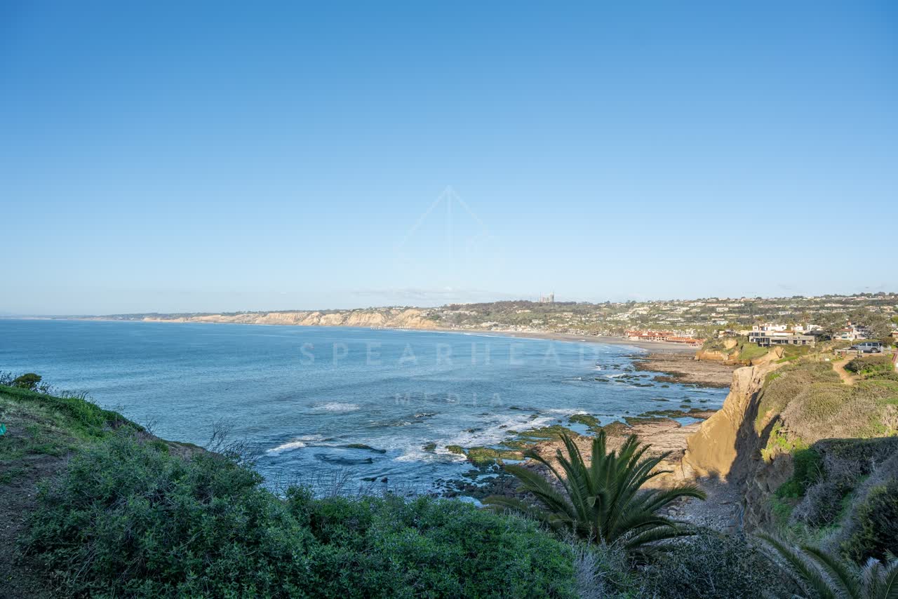 Elevated view of the cliffs, palm trees and the ocean at Coast Walk Trail.