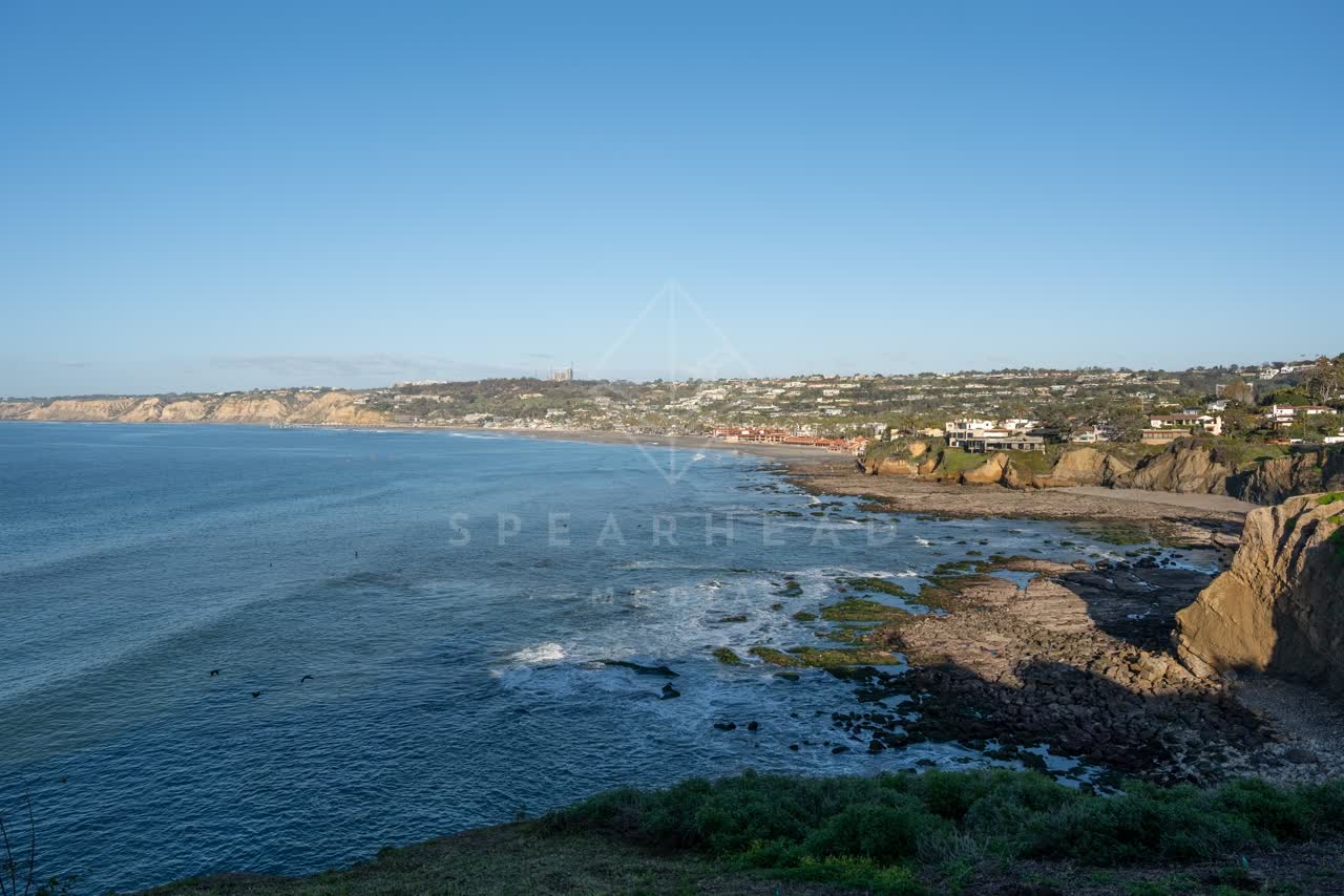 Elevated view of the cliffs, the ocean and homes at Coast Walk Trail.
