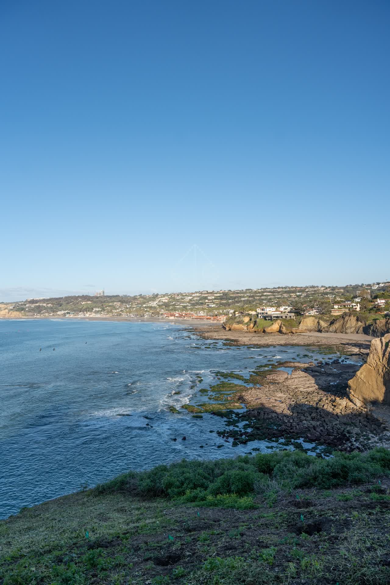 Elevated view of the cliffs, the ocean and homes at Coast Walk Trail.