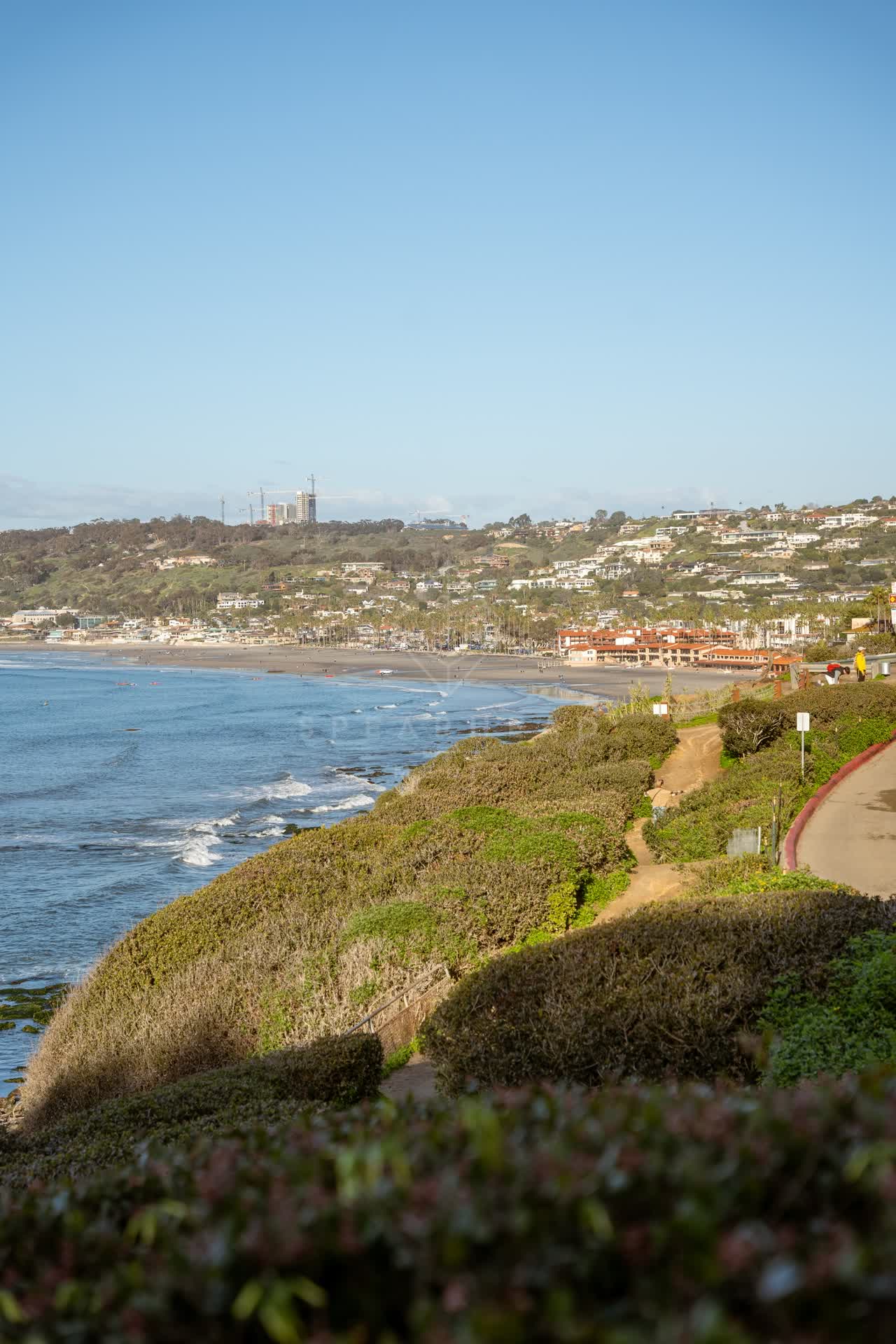 Elevated view of the cliffs, boats and the ocean at Coast Walk Trail.
