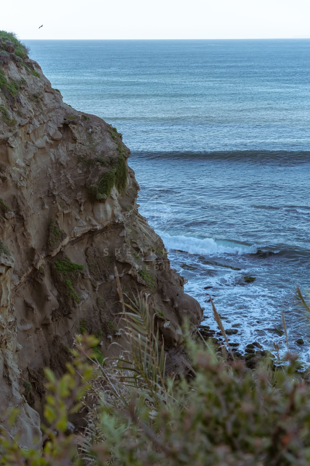Elevated view of the cliffs, the surf and the ocean at Coast Walk Trail.
