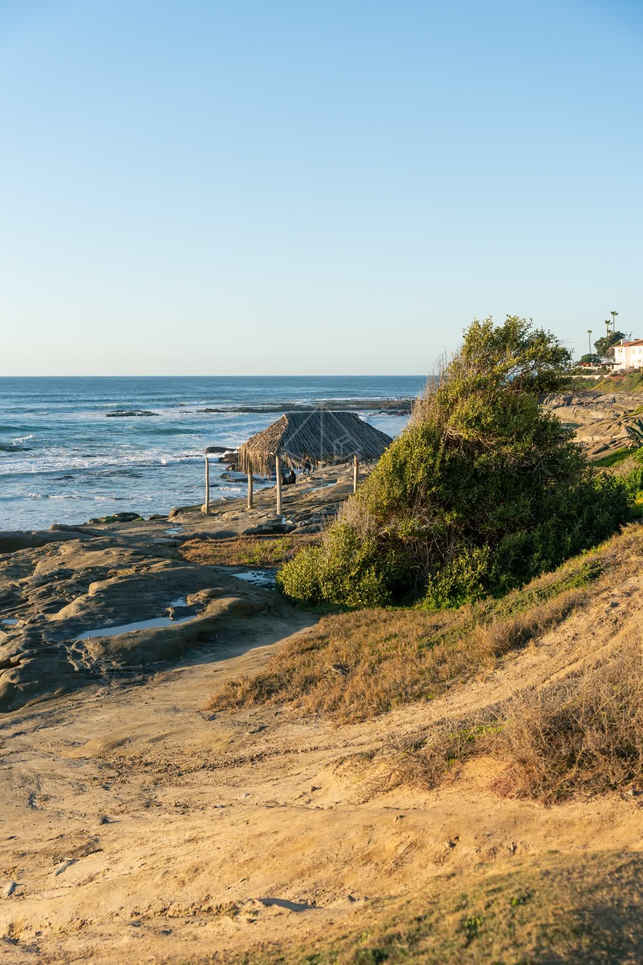 Elevated view of the cliffs, the surf and the ocean at Windansea.