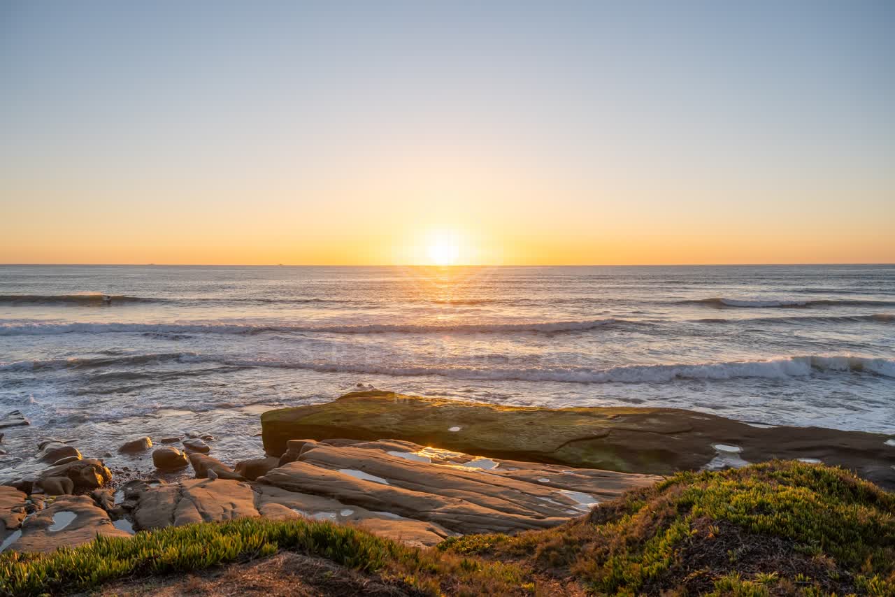 Elevated view of the cliffs, the surf and the ocean at Windansea.