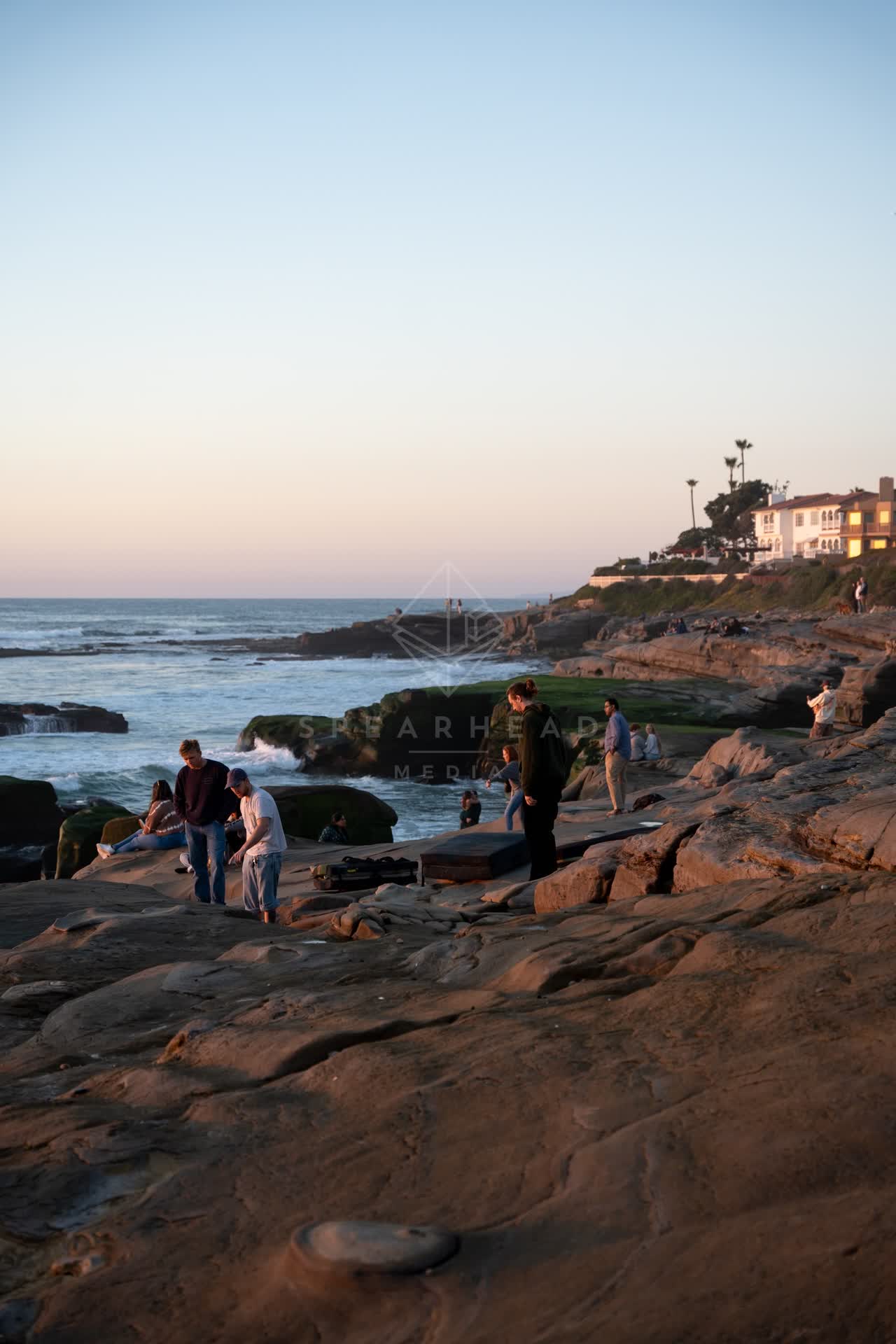 The cliffs, the surf and the ocean at Windansea, with a crowd gathered.