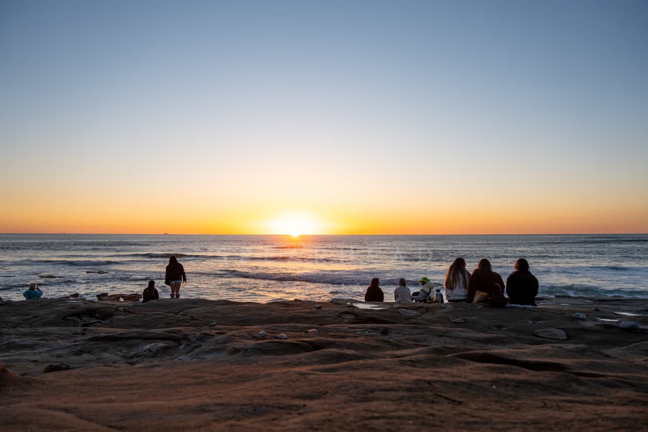 The cliffs, the surf and the ocean at Windansea, with a crowd gathered.