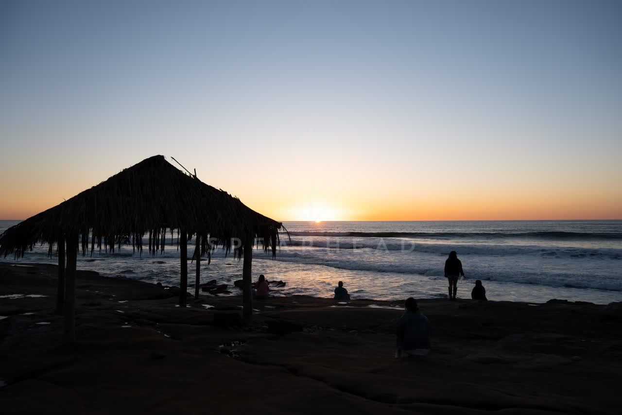 The beach, the surf and the ocean at Windansea, with a crowd gathered.