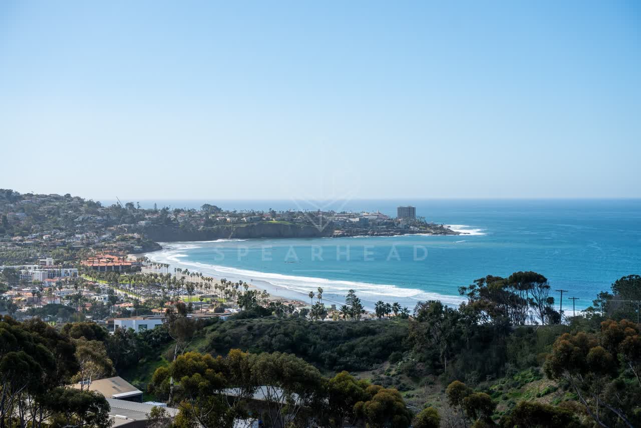 Elevated view of the cliffs, palm trees and the ocean at La Jolla Shores.