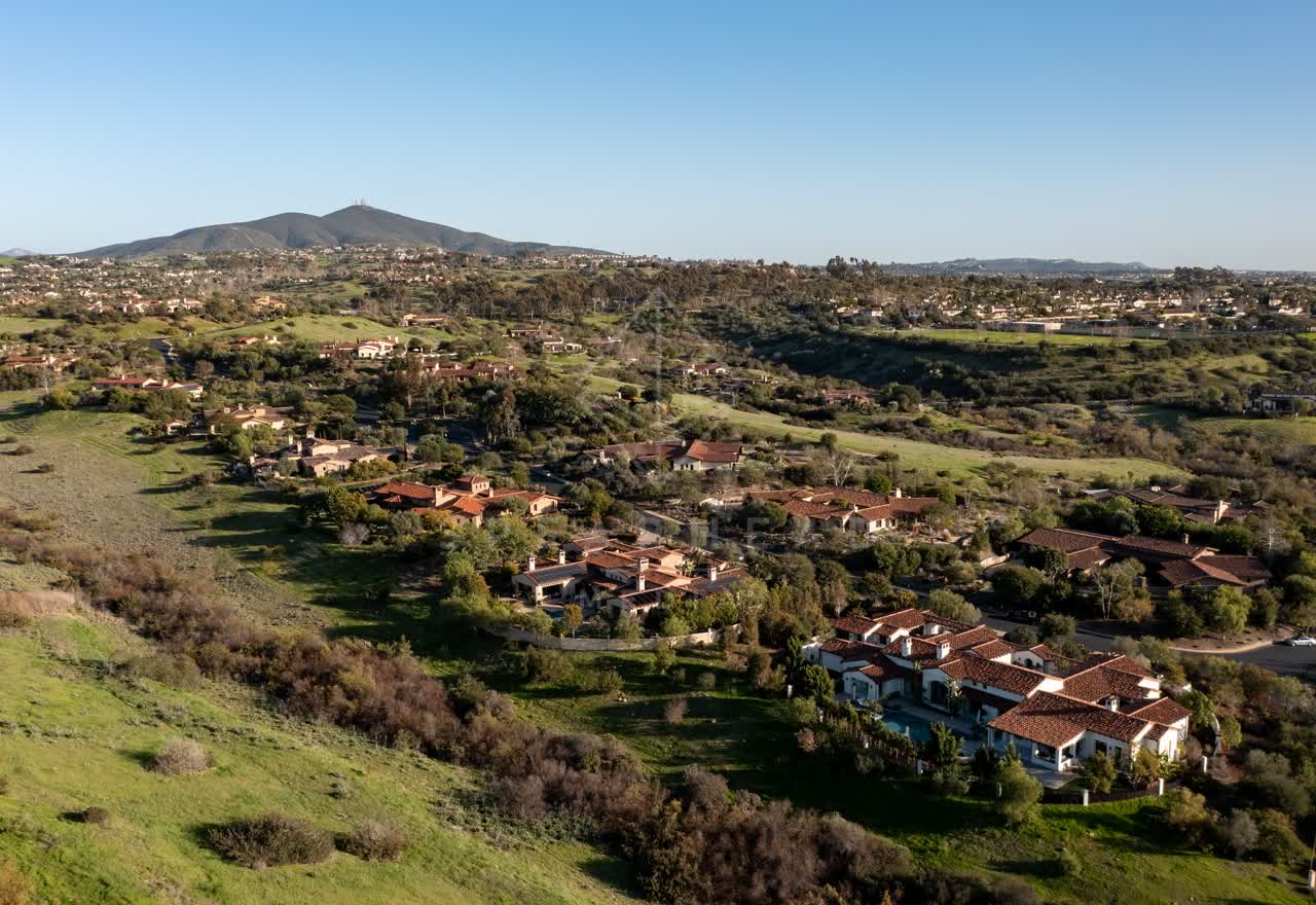 Aerial view of a residential street, homes and the buildings in Black Mountain Ranch.