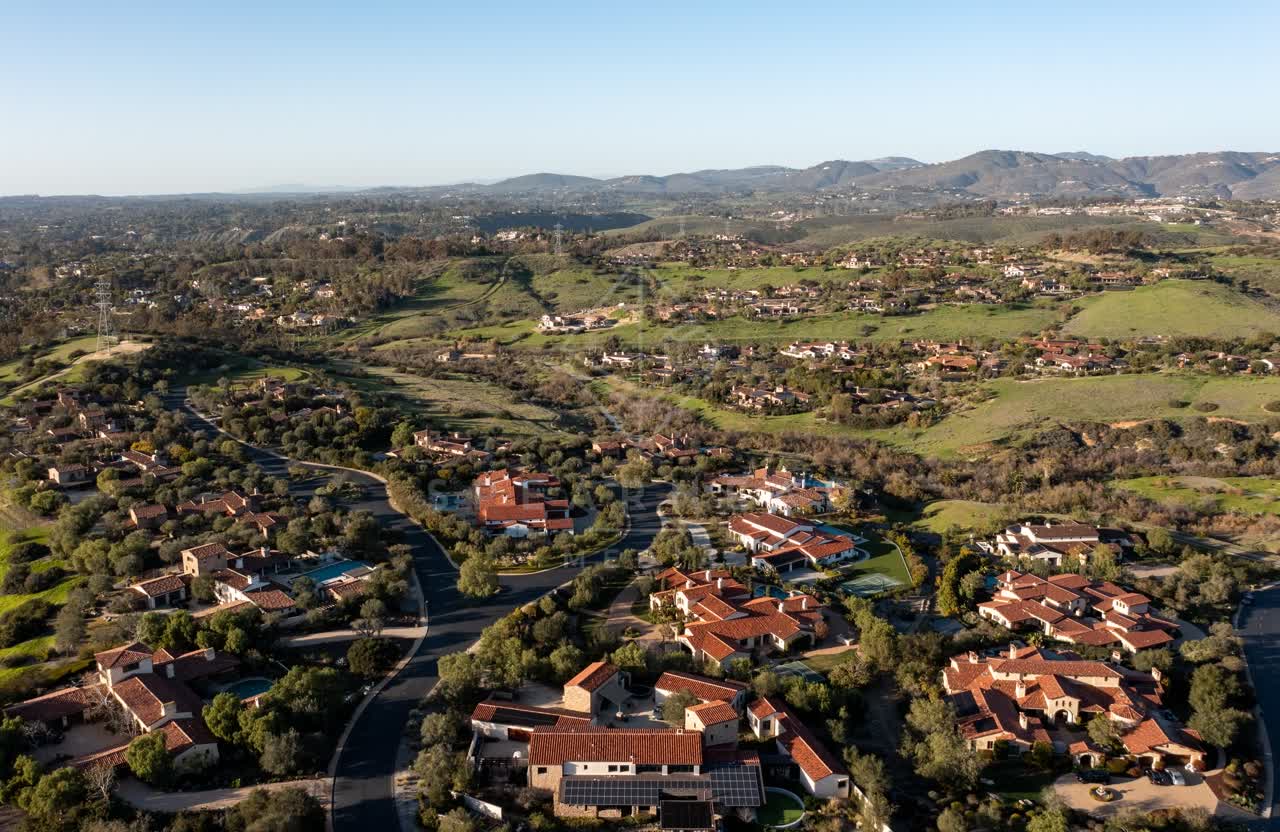 Aerial view of a residential street, homes and the buildings in Black Mountain Ranch.