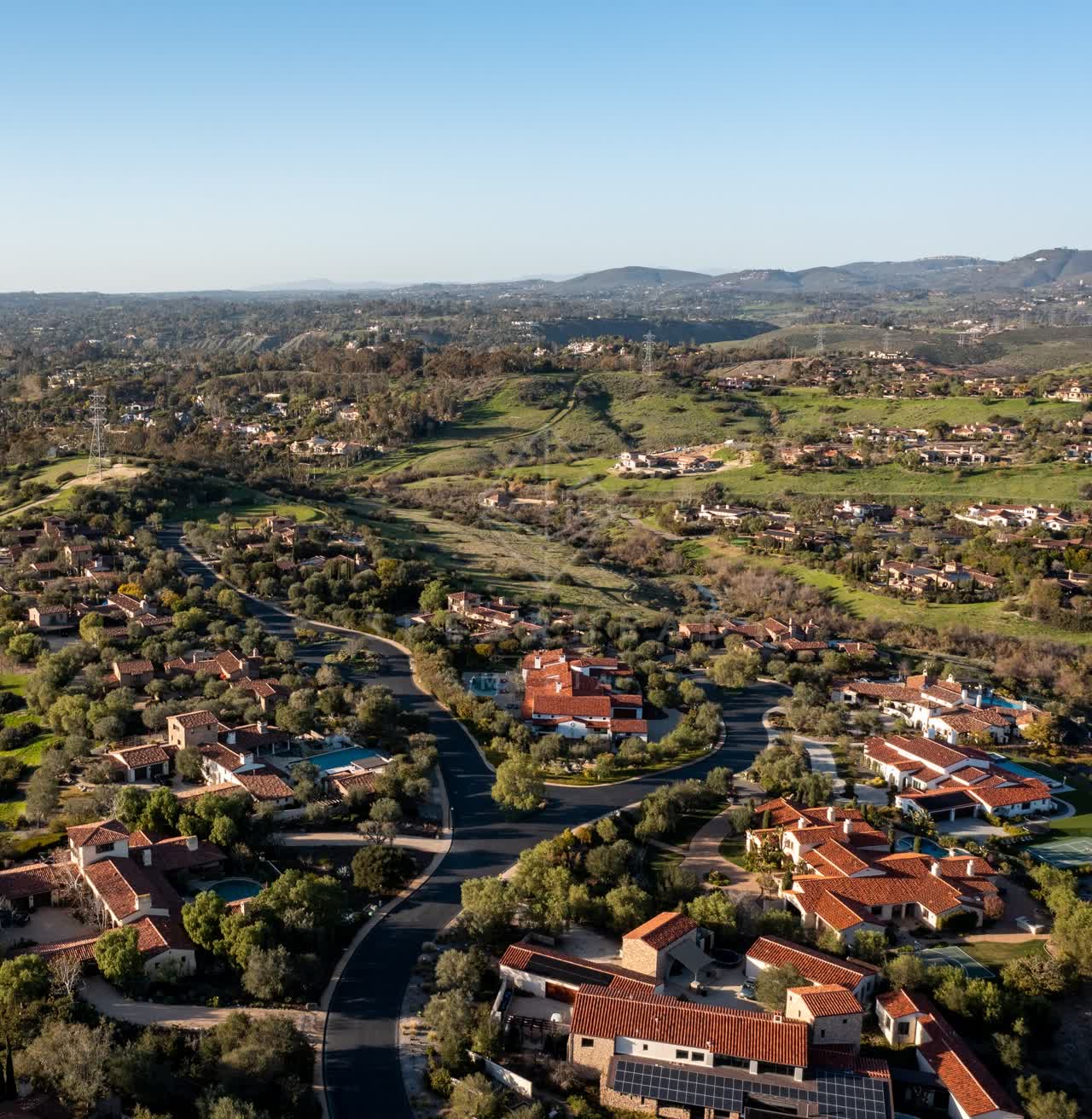 Aerial view of a residential street, homes and traffic in Black Mountain Ranch.