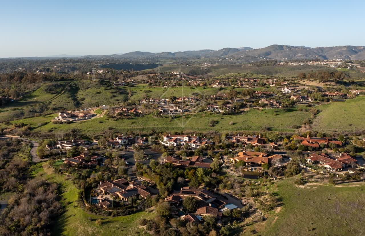 Aerial view of a residential street, homes and the buildings in Black Mountain Ranch.