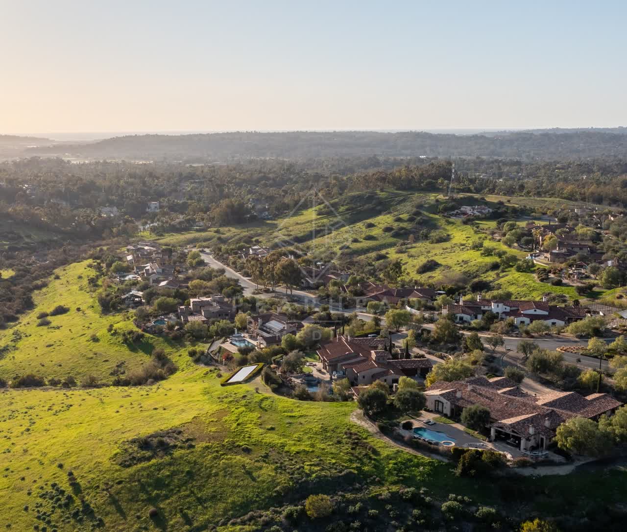 Aerial view of a residential street, homes and the buildings in Black Mountain Ranch.