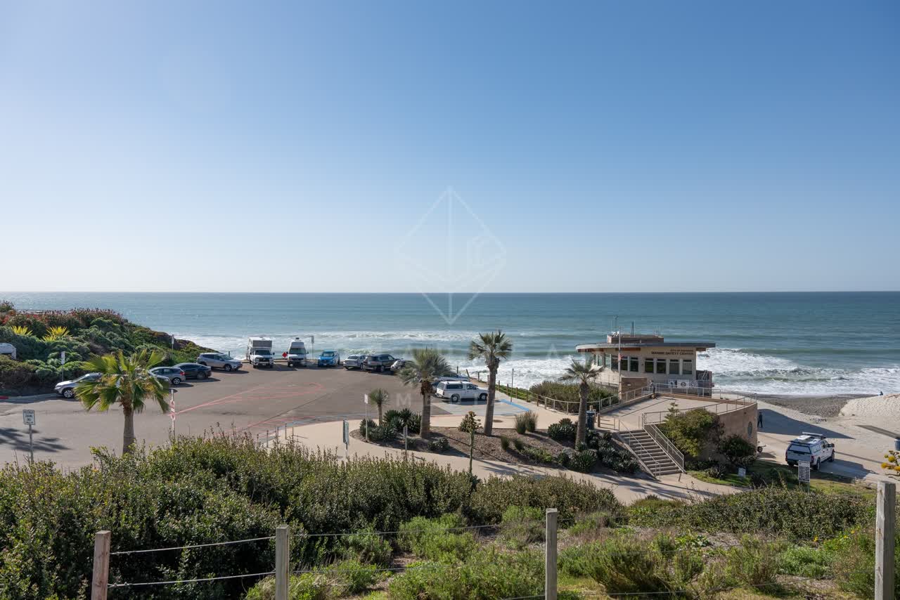 Elevated view of the beach, palm trees and the ocean at Moonlight Beach.