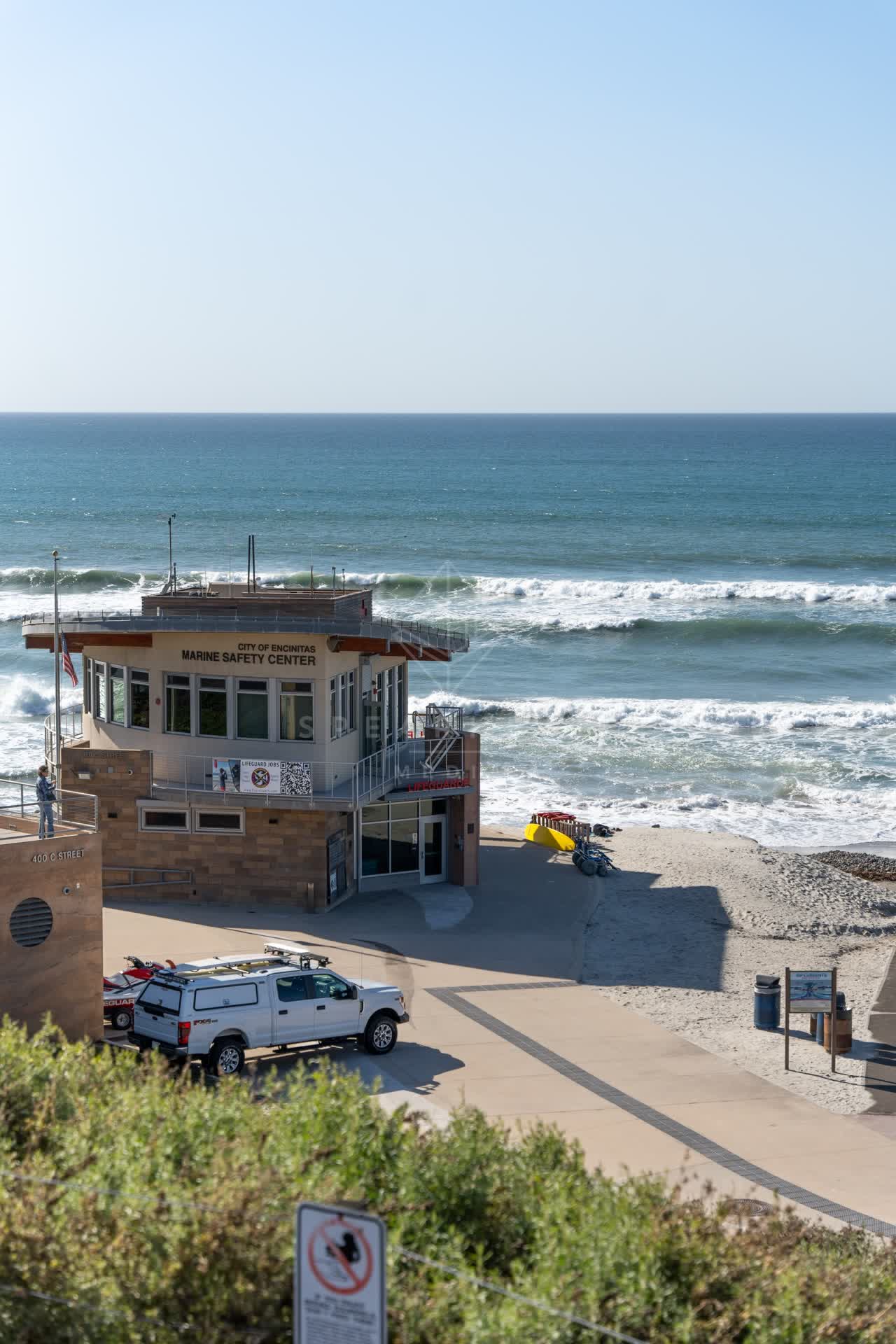 Elevated view of the beach, the surf and the ocean at Moonlight Beach.