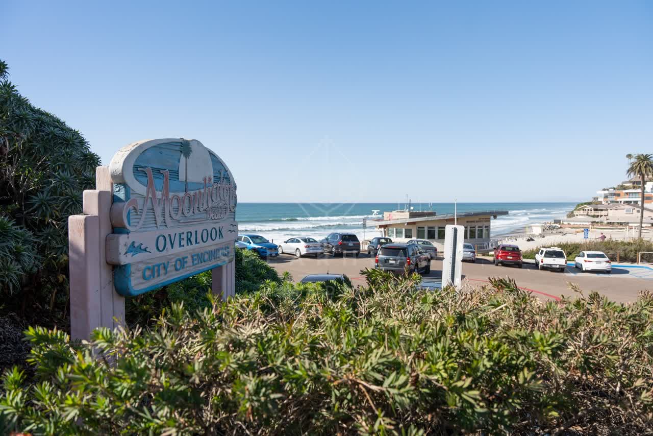 Elevated view of the beach, the surf and palm trees at Moonlight Beach.