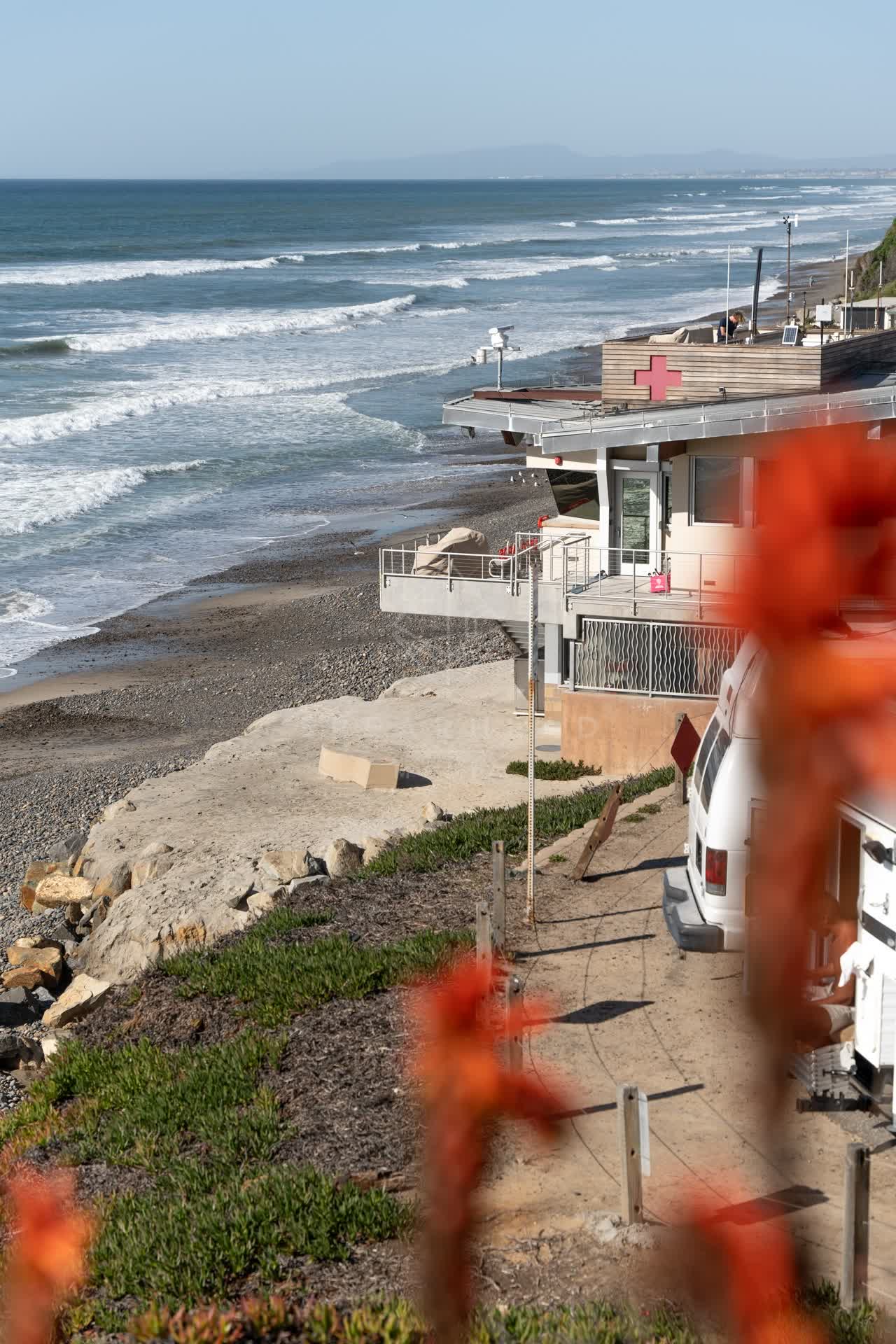 Elevated view of the beach, the surf and the ocean at Moonlight Beach.
