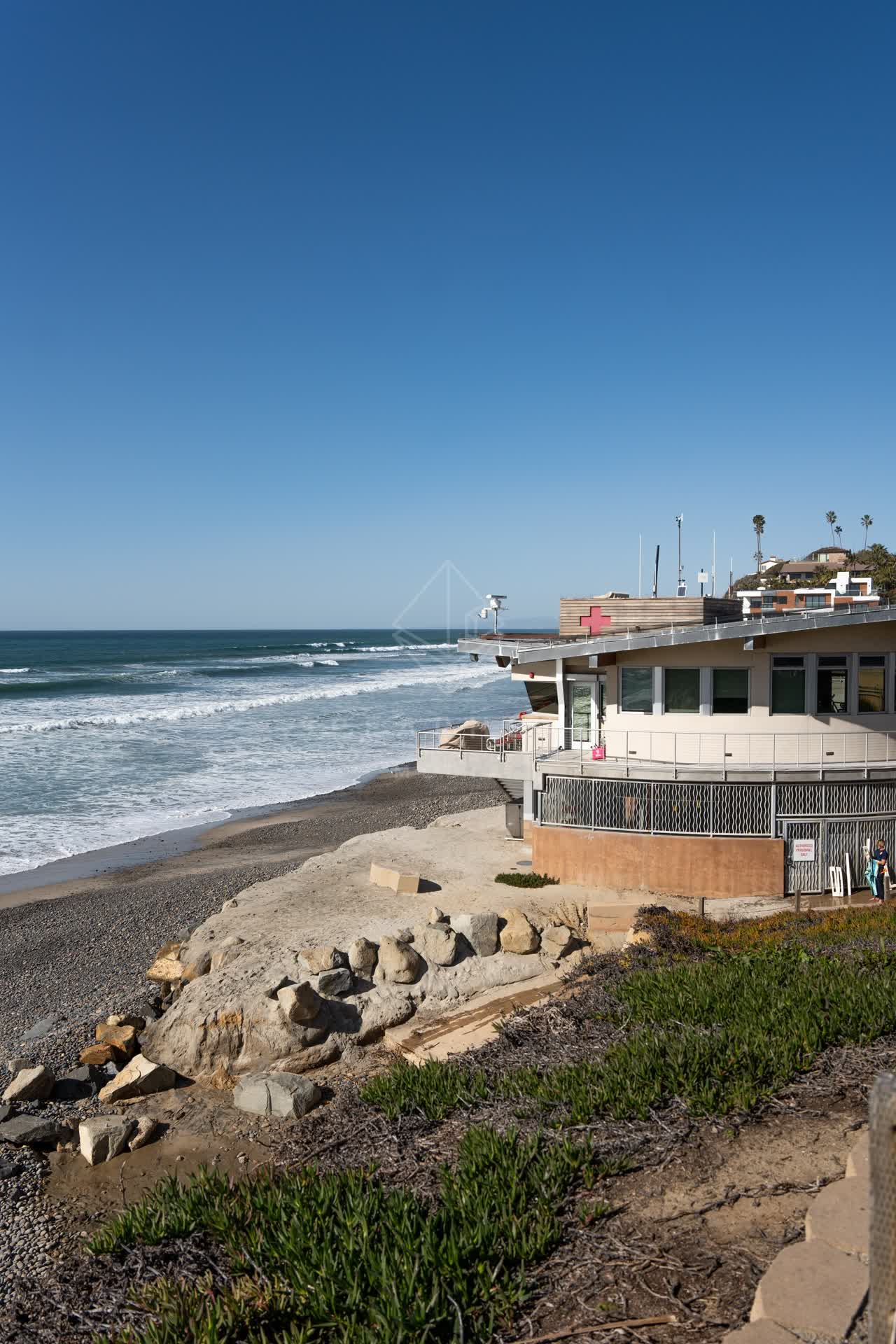 Elevated view of the beach, the surf and palm trees at Moonlight Beach.