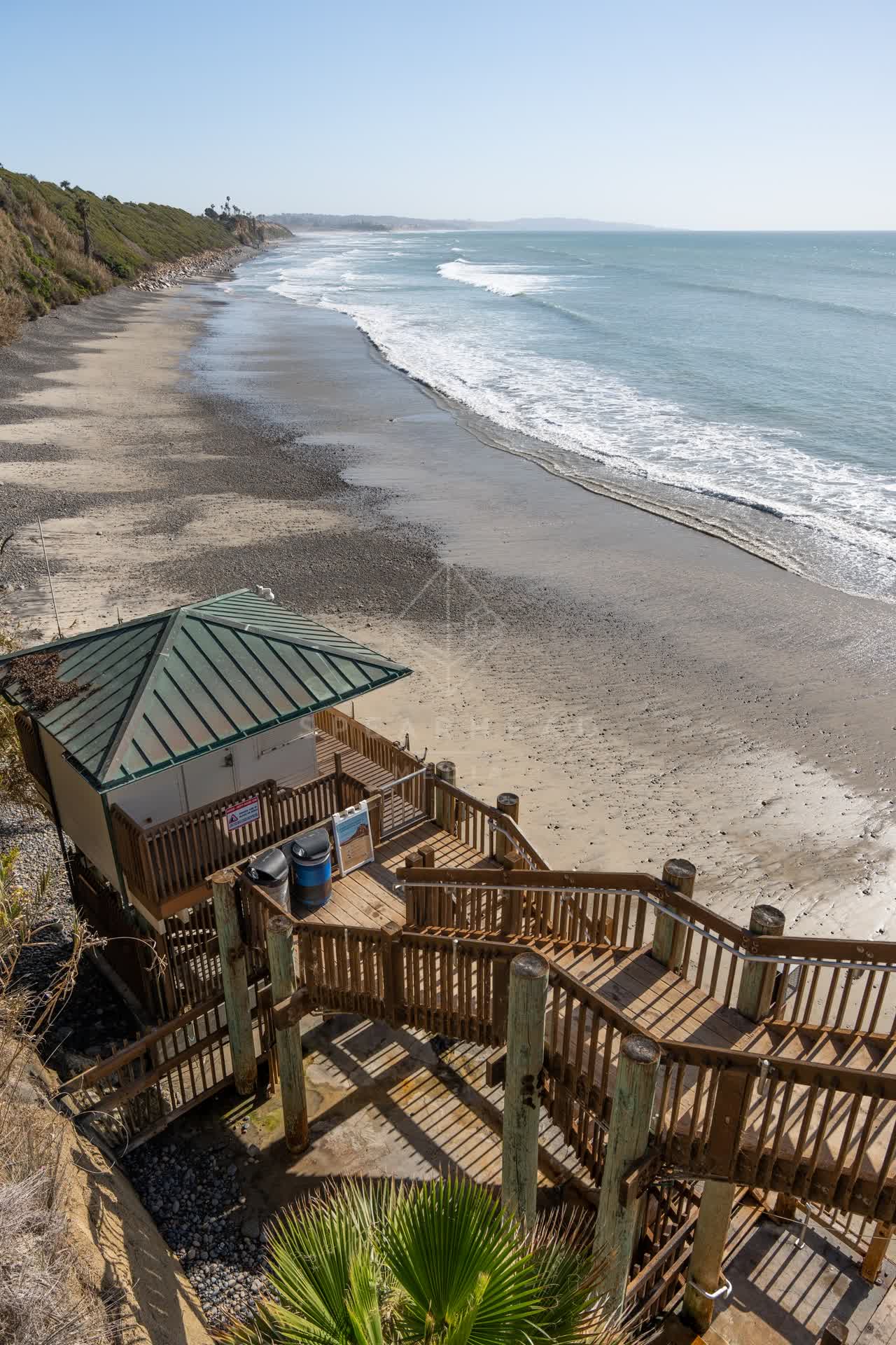 Elevated view of the cliffs, the surf and the ocean at Swamis.