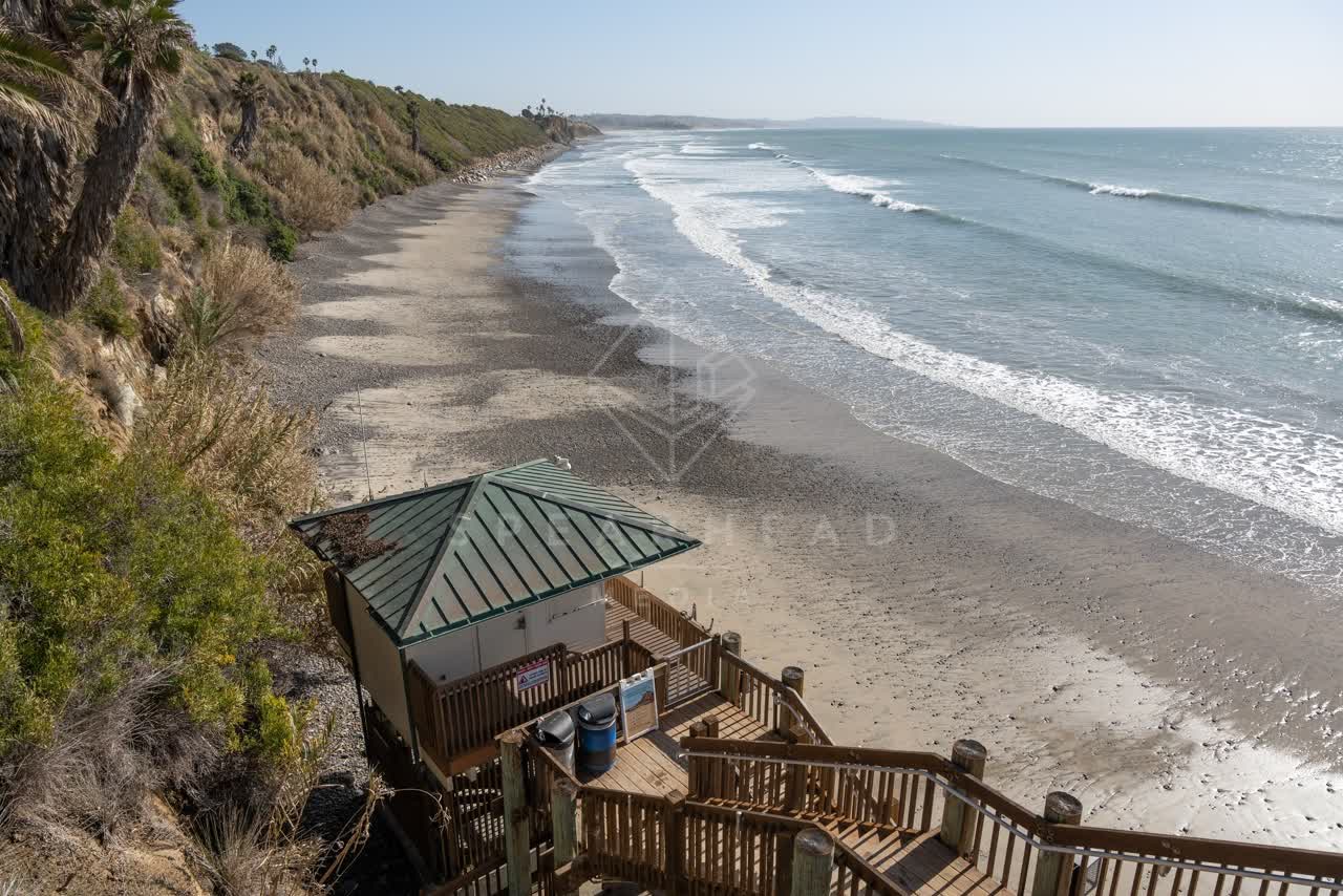 Elevated view of the cliffs, the surf and the pier at Swamis.