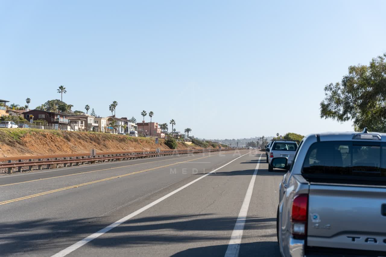 A residential street, palm trees and homes at Swamis.