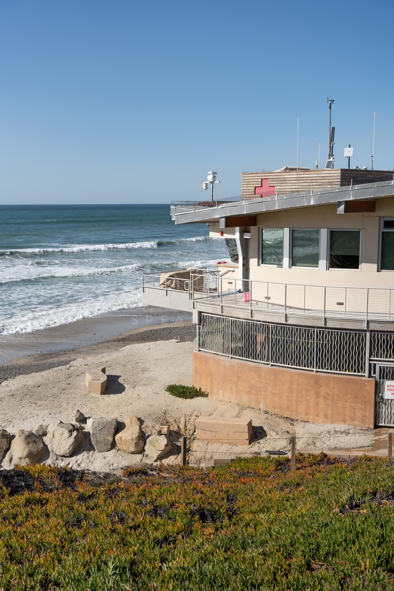 Elevated view of the beach, the surf and the ocean at Moonlight Beach.