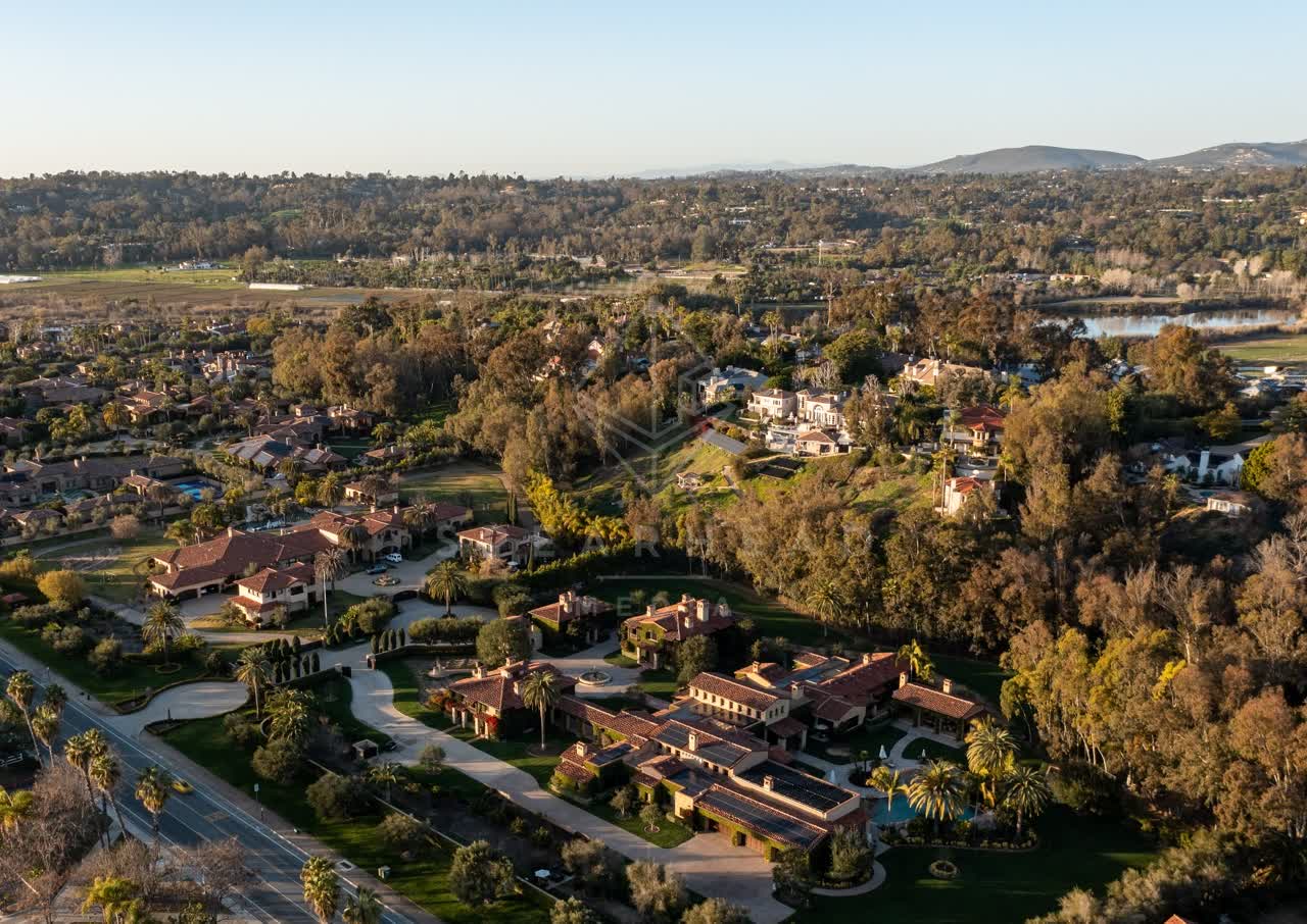 Aerial view of a residential street, homes and open country at Fairbanks Ranch.