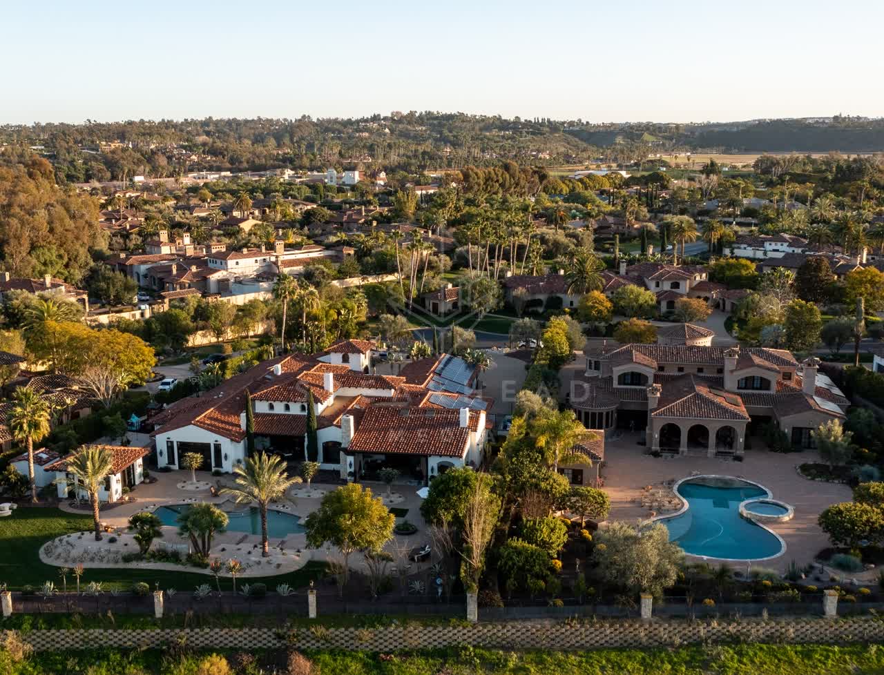 Aerial view of a residential street, palm trees and homes at Fairbanks Ranch.