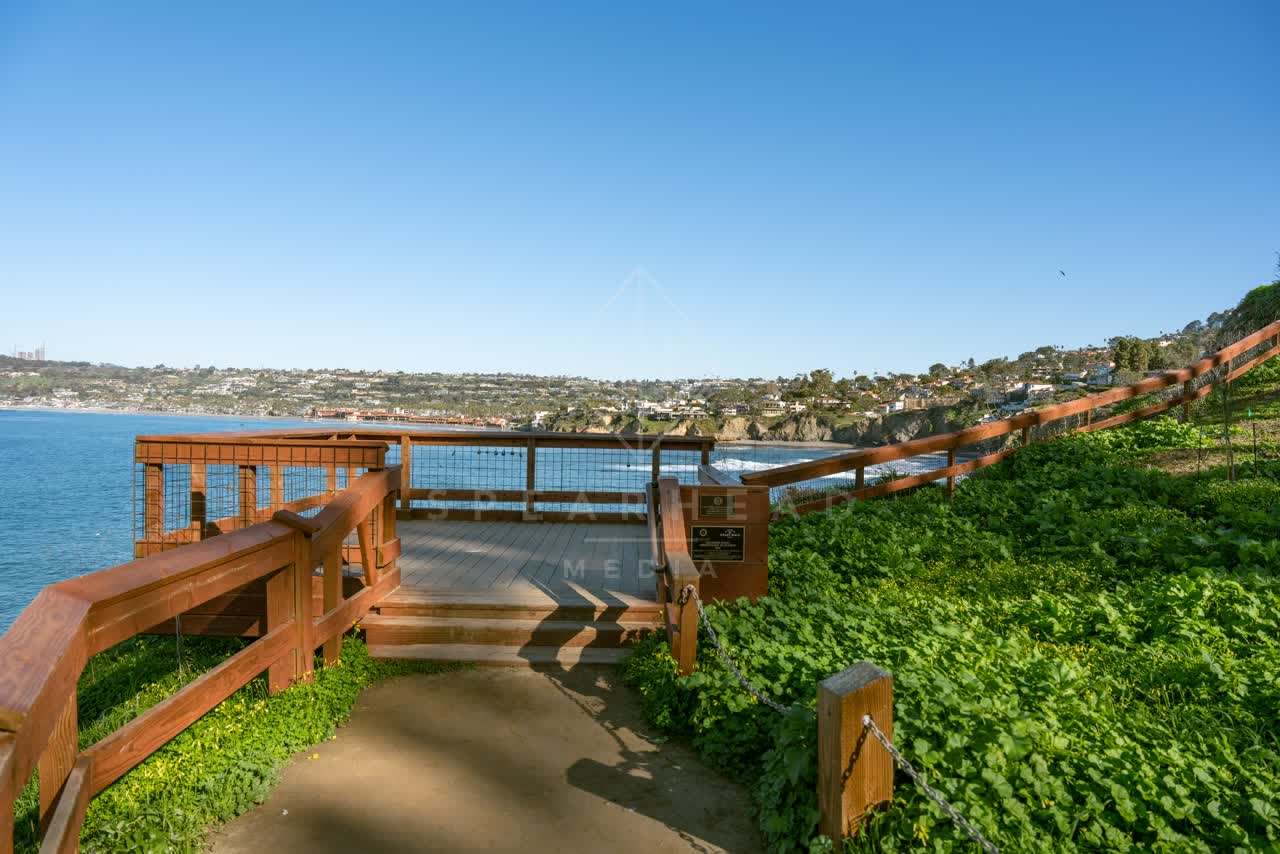 Elevated view of the cliffs, the ocean and homes at Coast Walk Trail.